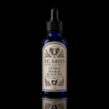 A 2 oz cobalt blue glass dropper bottle of St. Aries Citrus Hair & Scalp Oil, featuring a cream-colored label with black text and a ram illustration, set against a solid black background with a reflection below.
